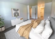 Thumbnail 9 of 23 - a bedroom with a bed with white pillows and a tan blanket