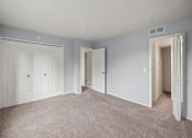 Thumbnail 13 of 23 - an empty bedroom with blue walls and white doors
