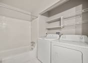 Thumbnail 15 of 23 - a white laundry room with a washer and dryer