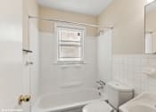 Thumbnail 6 of 16 - a white bathroom with a tub and a toilet and a sink