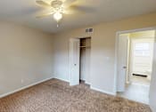 Thumbnail 3 of 26 - Bedroom with a ceiling fan and carpeted floor.