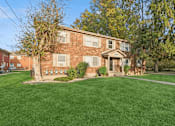 Thumbnail 15 of 16 - brick apartment building with green grass and trees