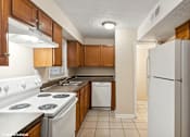 Thumbnail 1 of 16 - apartment kitchen with white appliances and wooden cabinets