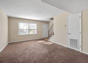 Thumbnail 11 of 16 - carpeted living room at Preston Oaks Apartments