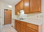 Thumbnail 3 of 33 - apartment kitchen with wooden cabinets