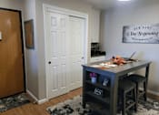Thumbnail 3 of 8 - A room with a desk and a framed sign on the wall.
