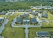 Thumbnail 33 of 33 - A bird's eye view of a residential area with houses and a swimming pool.