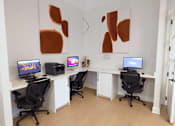 Thumbnail 8 of 33 - A room with two desks and two chairs.