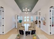 Thumbnail 11 of 33 - A hallway with a green ceiling and a white floor.