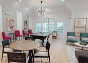 Thumbnail 9 of 33 - A room with a round table surrounded by chairs and a pool table.