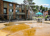Thumbnail 17 of 23 - A water fountain in the middle of a courtyard.