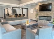 Thumbnail 8 of 18 - a apartment community clubhouse with couches and a television