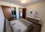 Thumbnail 7 of 16 - a bedroom with a bed and a mirror