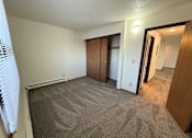 Thumbnail 10 of 16 - A room with carpeted floor and a window with blinds.