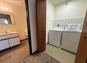 Thumbnail 14 of 16 - A laundry room with a washer and dryer.