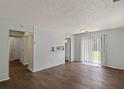 Thumbnail 1 of 27 - a living room with a wood style floor and a sliding glass door