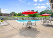 Thumbnail 17 of 27 - a pool with chairs and umbrellas next to a pool