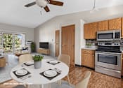 Thumbnail 2 of 11 - A modern kitchen with a dining table set for four.