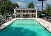 Thumbnail 26 of 31 - A swimming pool in front of a two-story house.