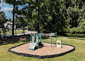 Thumbnail 27 of 31 - A playground with a green slide and a sign.