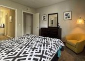 Thumbnail 9 of 29 - a bedroom with a large bed and a yellow chair