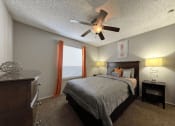Thumbnail 10 of 29 - a bedroom with a bed and a ceiling fan