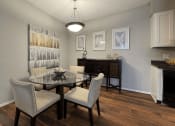 Thumbnail 2 of 29 - a dining room with a table and chairs