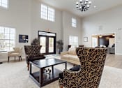 Thumbnail 17 of 35 - A living room with a patterned chair and a coffee table.