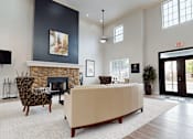 Thumbnail 16 of 35 - A living room with a fireplace and a couch.