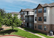 Thumbnail 32 of 35 - Apartment complex with a red fountain in the front yard.
