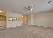 Thumbnail 8 of 35 - A spacious room with a ceiling fan and carpeted floor.