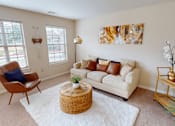 Thumbnail 5 of 35 - A living room with a white couch, a brown chair, and a wicker table.