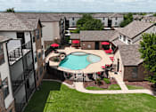 Thumbnail 24 of 35 - A pool surrounded by a fence and patio furniture.
