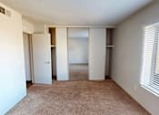 Thumbnail 11 of 26 - A room with a carpeted floor and white walls.