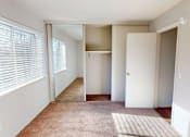 Thumbnail 10 of 26 - A room with a carpet, a rug, and a door.
