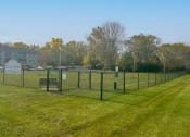 Thumbnail 20 of 22 - a chain link fence in a field with grass