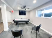 Thumbnail 16 of 22 - a game room with an air hockey table and a flat screen tv