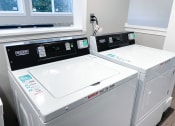 Thumbnail 19 of 22 - a washer and dryer sit next to each other in a laundry room