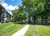 Thumbnail 29 of 35 - sidewalk with large shady trees at rivers edge apartments