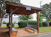 Thumbnail 31 of 32 - a wooden bench sitting under a wooden pavilion