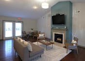 Thumbnail 16 of 32 - a living room with a fireplace and a television