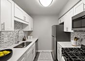 Thumbnail 5 of 31 - A kitchen with a black stove top oven and a black refrigerator.