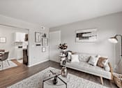Thumbnail 1 of 31 - A living room with a white couch and a coffee table.