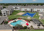 Thumbnail 26 of 35 - A pool with a basketball court in the background.