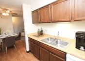 Thumbnail 6 of 22 - a kitchen with wooden cabinets and a stainless steel sink