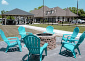 Thumbnail 24 of 33 - a fire pit with four blue adirondack chairs in front of a gazeb