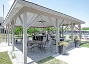 Thumbnail 23 of 33 - a covered patio with tables and chairs