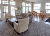 Thumbnail 12 of 33 - a living room with couches and chairs and a dining room with tables and chairs