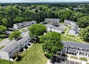 Thumbnail 36 of 39 - A large building complex surrounded by trees.