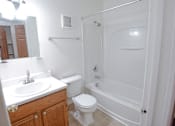 Thumbnail 11 of 29 - A white bathroom with a toilet, sink, and bathtub.